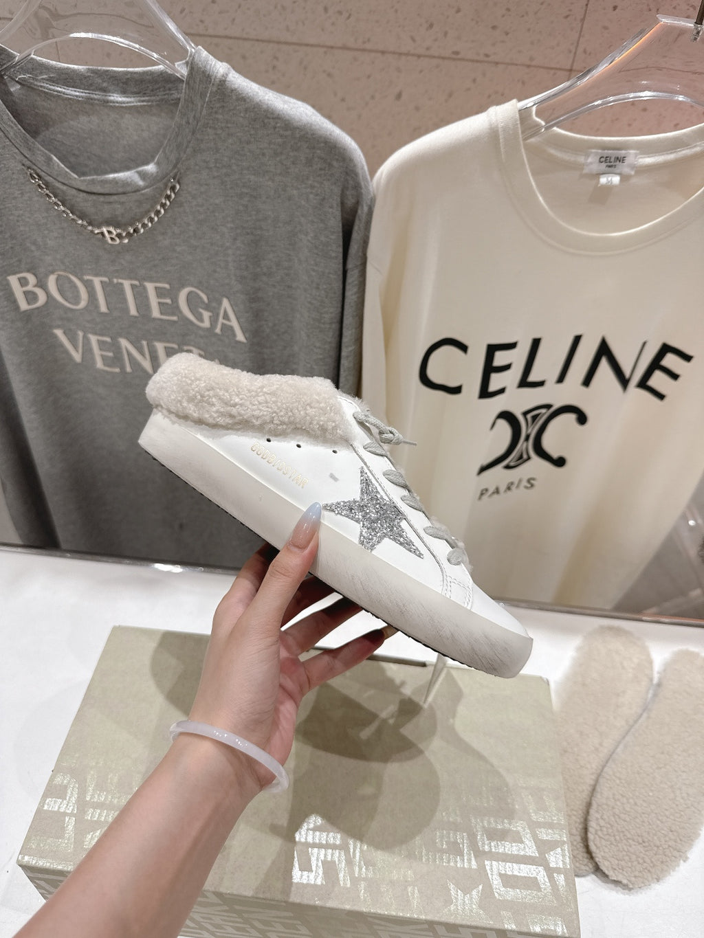 Golden Goose sneaker close-up, white leather with gray glitter side detail and plush cuff