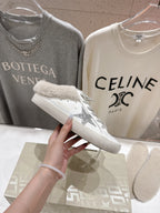 Golden Goose sneaker close-up, white leather with gray glitter side detail and plush cuff