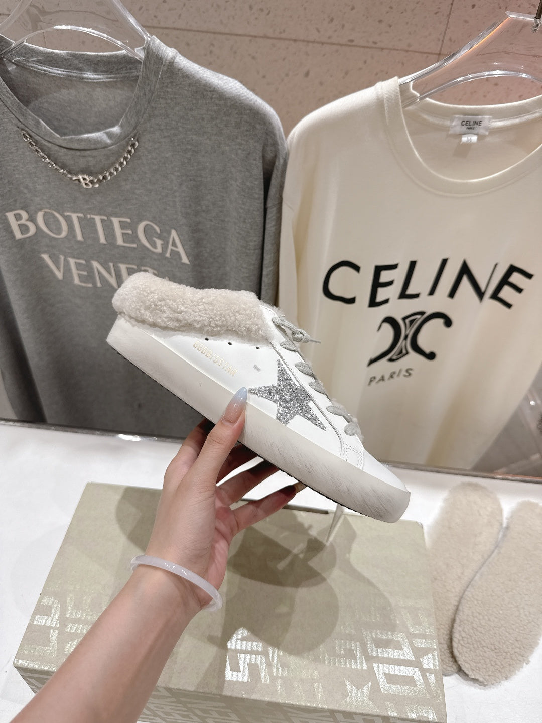 Golden Goose sneaker close-up, white leather with gray glitter side detail and plush cuff