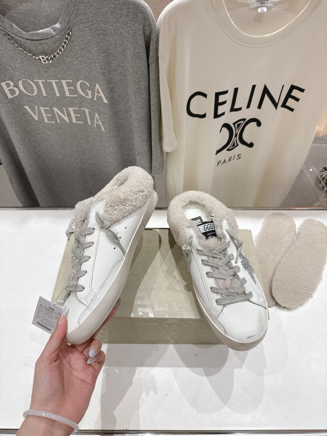 Golden Goose sneaker pair, white leather with gray glitter trim and teddy-fleece tongue