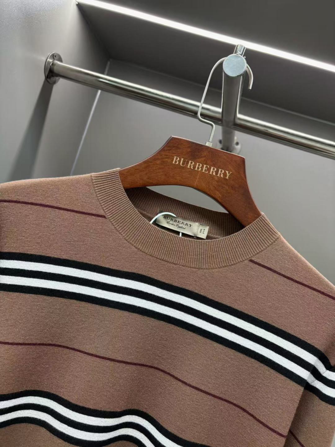 Brown crew-neck knit sweater with thick black-and-white horizontal stripes