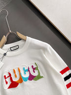 White crewneck sweatshirt with multicolor Gucci logo and striped sleeve cuff