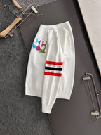 White long pants with multicolor logo patch and red/black/white stripe detail