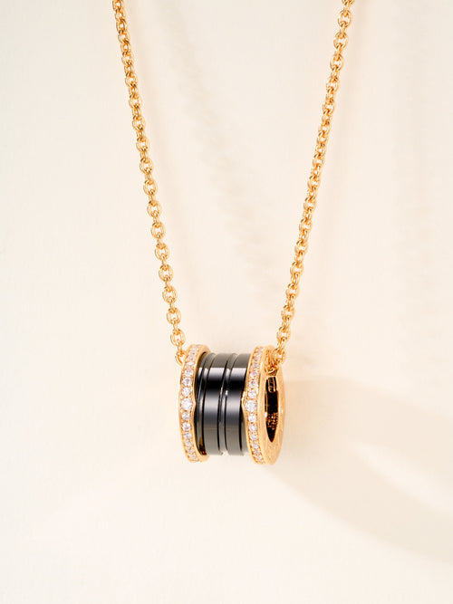 Bvlgari necklace pendant with gold ring charms, black enamel insets, and crystal pavé trim