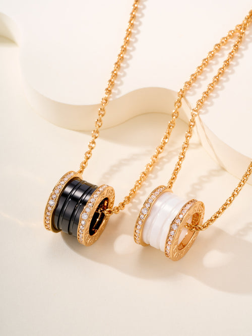 Bvlgari necklace with gold ring charms, black enamel bands, and crystal pavé accents