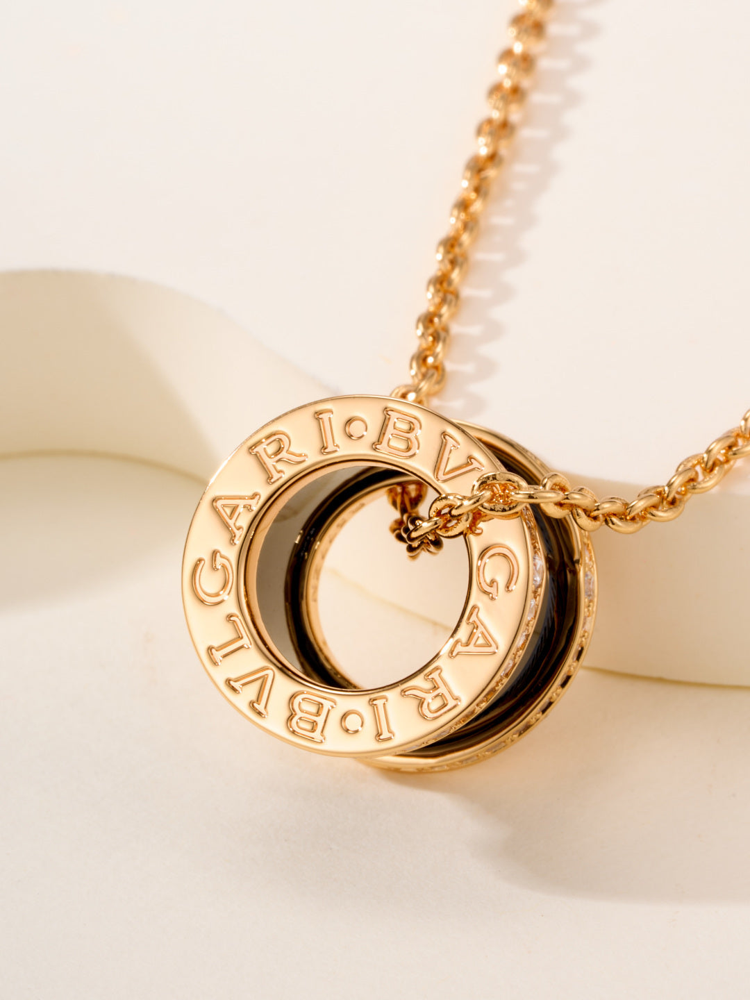 Bvlgari necklace with round engraved logo pendant in gold-tone