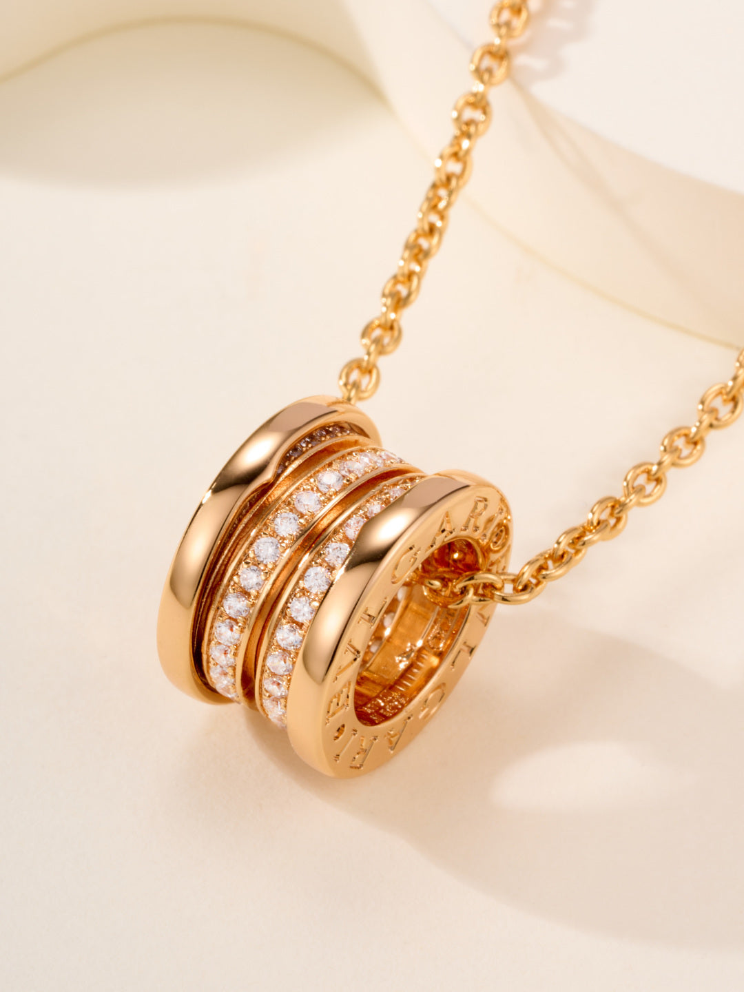 Bvlgari gold necklace with engraved cylindrical disc pendant