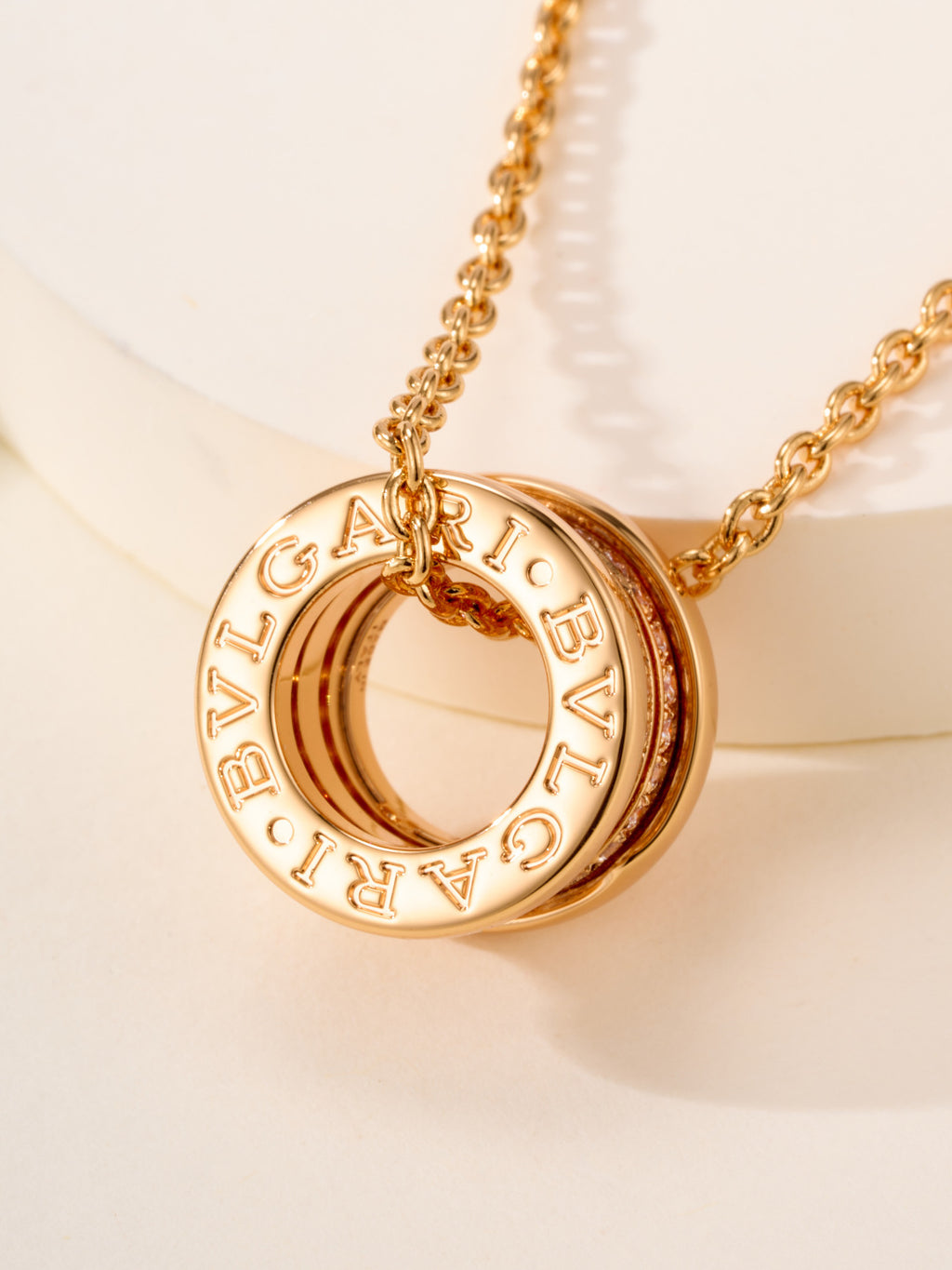 Bvlgari gold necklace with engraved 'BVLGARI' ring pendant