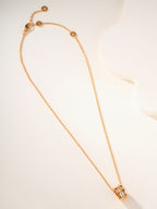 Gold-tone long chain necklace with hook clasp and small circular charm ends