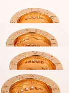Set of gold-tone circular medallion discs with engraved markings and gemstones