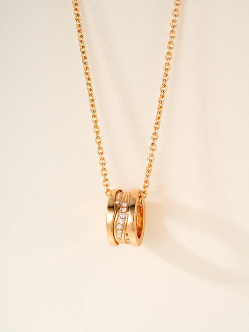 Gold-tone chain necklace with stacked ring pendant and small gemstone accents