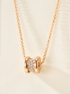 Gold necklace with pavé cylinder charm and linked chain