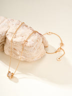 Gold necklace with dangling hoop charm and lobster clasp