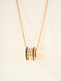 Bvlgari gold-tone necklace with cylindrical pendant and enamel accent rings