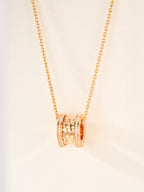 Gold-tone necklace with round hoop pendant and pavé crystal accents