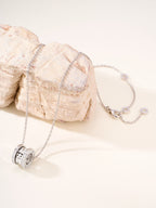 Silver-tone necklace with round hoop pendant and delicate chain links