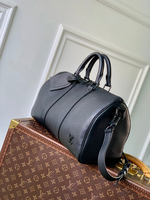 Louis Vuitton men’s dark blue leather bag with top handle and adjustable shoulder strap