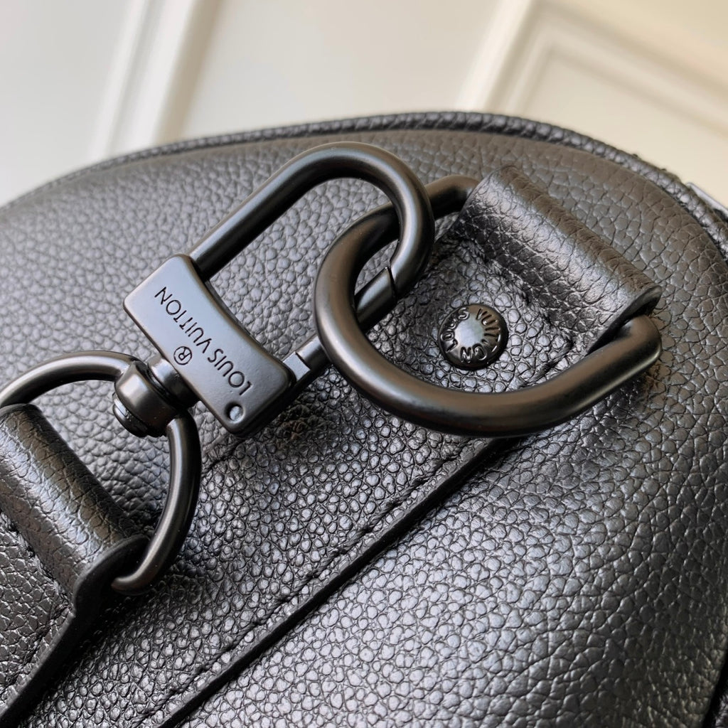 Louis Vuitton men’s dark blue leather bag close-up of handle hardware and logo tag