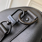 Louis Vuitton men’s dark blue leather bag close-up of handle hardware and logo tag