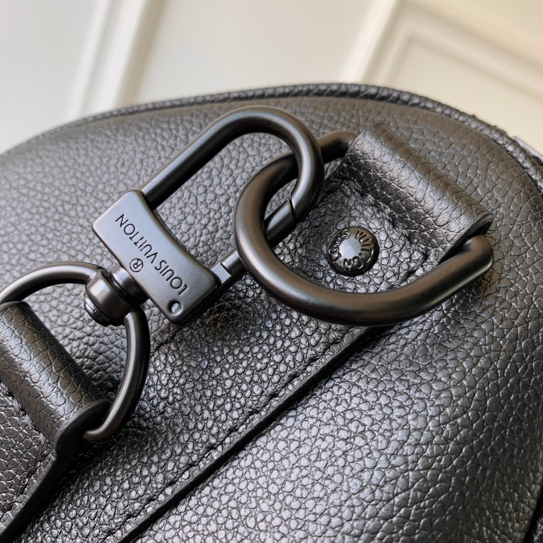 Louis Vuitton men’s dark blue leather bag close-up of handle hardware and logo tag