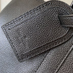Louis Vuitton men’s dark blue leather bag close-up of front panel and stitched flap