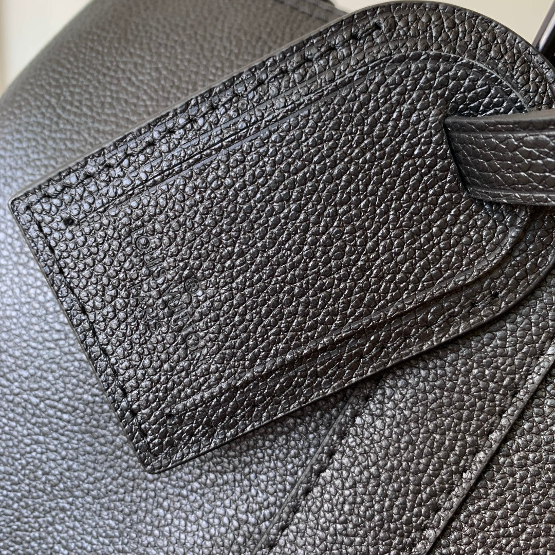 Louis Vuitton men’s dark blue leather bag close-up of front panel and stitched flap