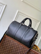 Louis Vuitton men’s dark blue leather bag with structured shape and top handle loop