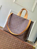 Louis Vuitton monogram tote bag with tan leather edging and twin top handles