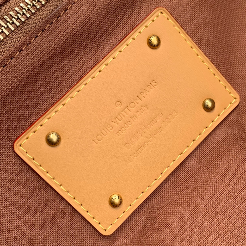 Louis Vuitton leather patch with stitched edges and gold-tone stud hardware