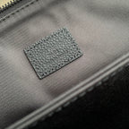 Men's Louis Vuitton zipper tab and small LV logo leather patch on dark blue bag