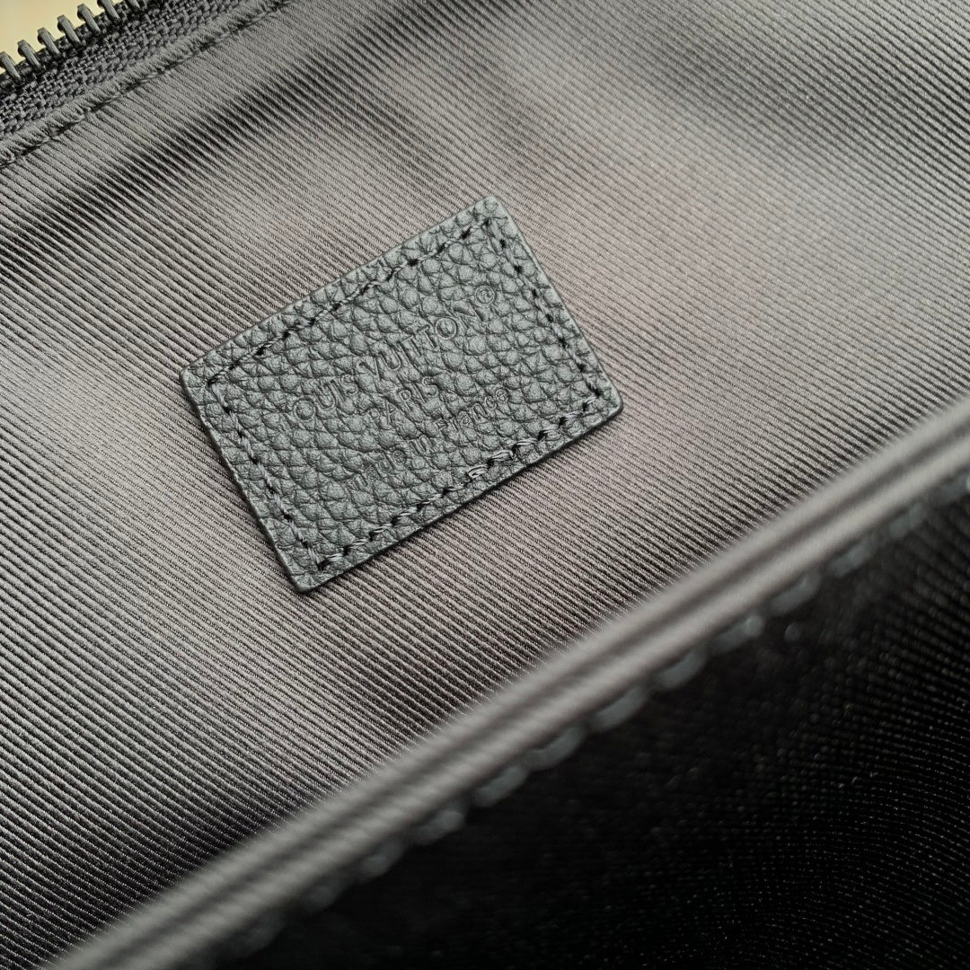 Men's Louis Vuitton zipper tab and small LV logo leather patch on dark blue bag