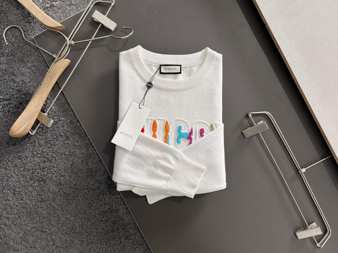 White crewneck sweatshirt with multicolor Gucci logo embroidery and ribbed hem