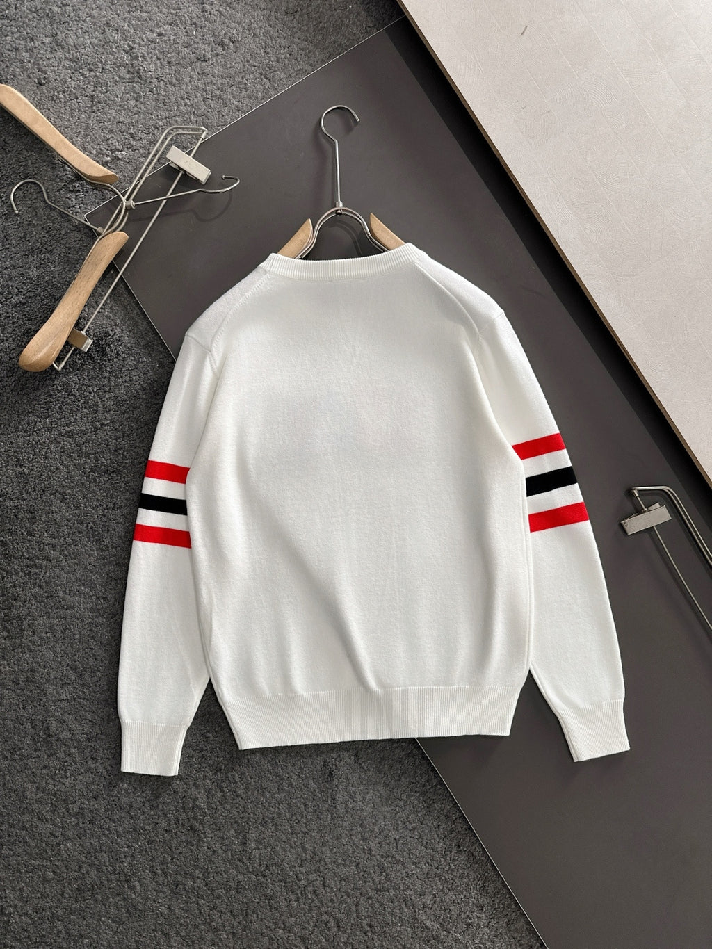 White crewneck sweatshirt back view with red/black/white striped sleeves