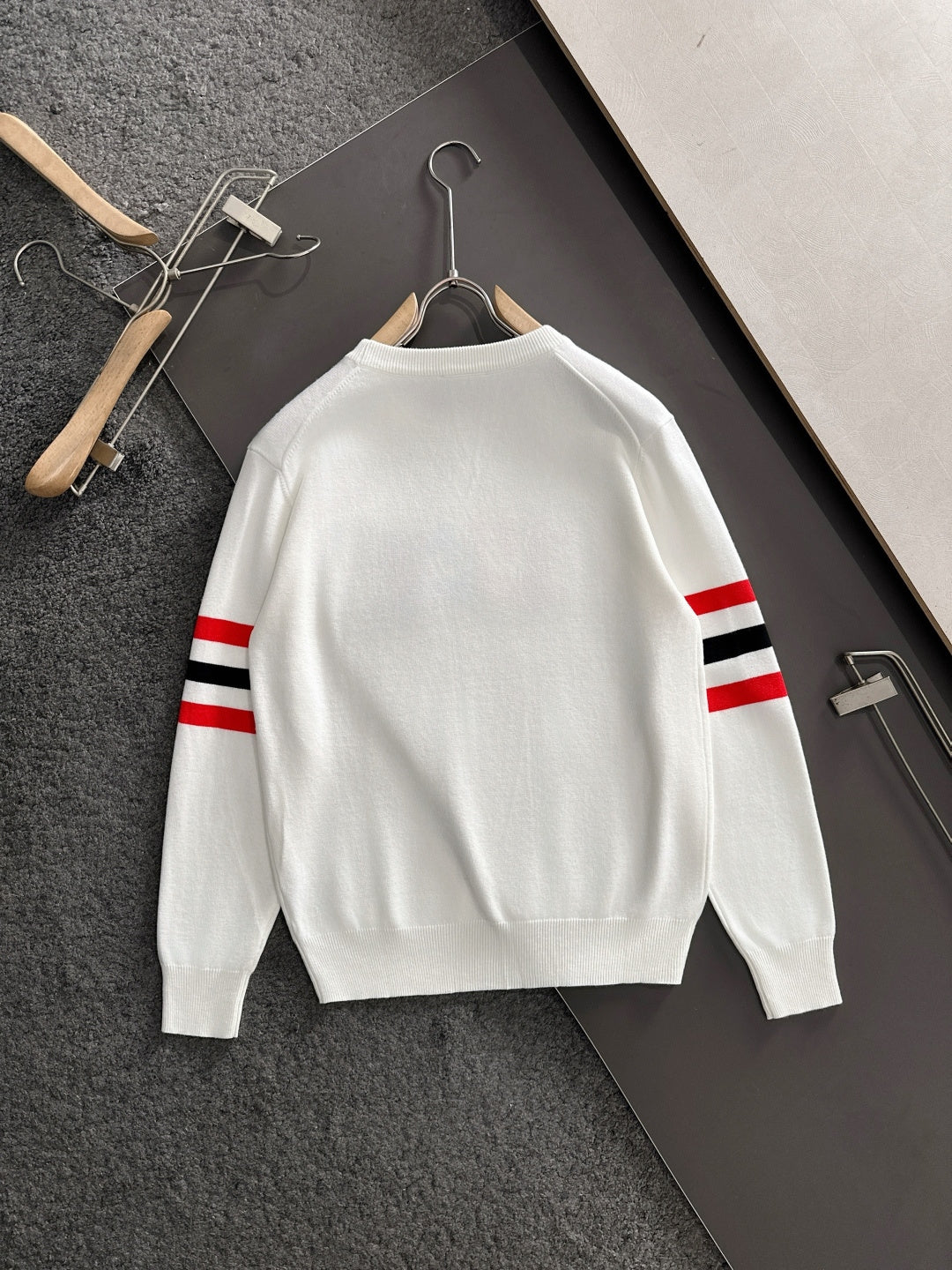 White crewneck sweatshirt back view with red/black/white striped sleeves
