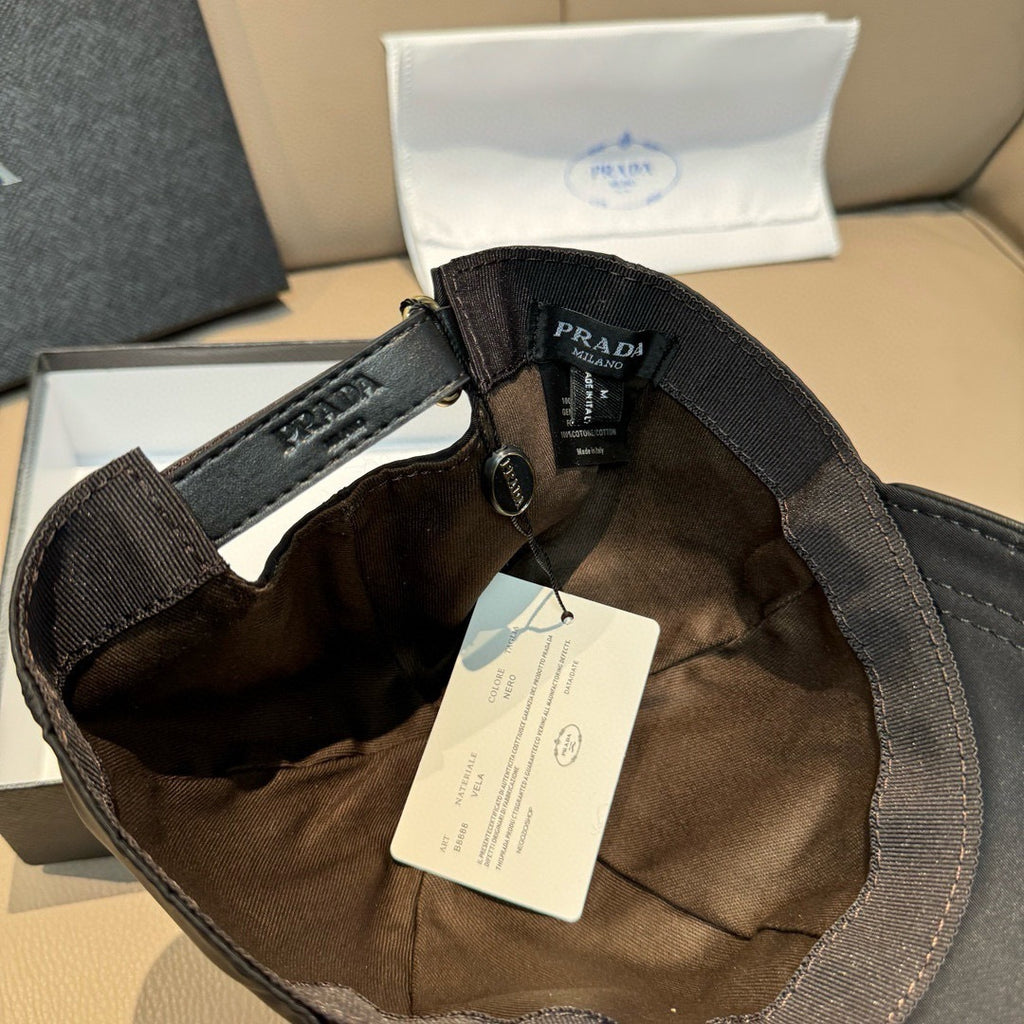 Black cap interior with adjustable strap and Prada logo patch on the crown.
