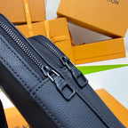 Louis Vuitton bag in dark blue grained leather, close-up of dual zippers and pull tabs.