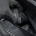 Louis Vuitton zip pouch lining close-up with zipper, fabric texture, and stitched label.