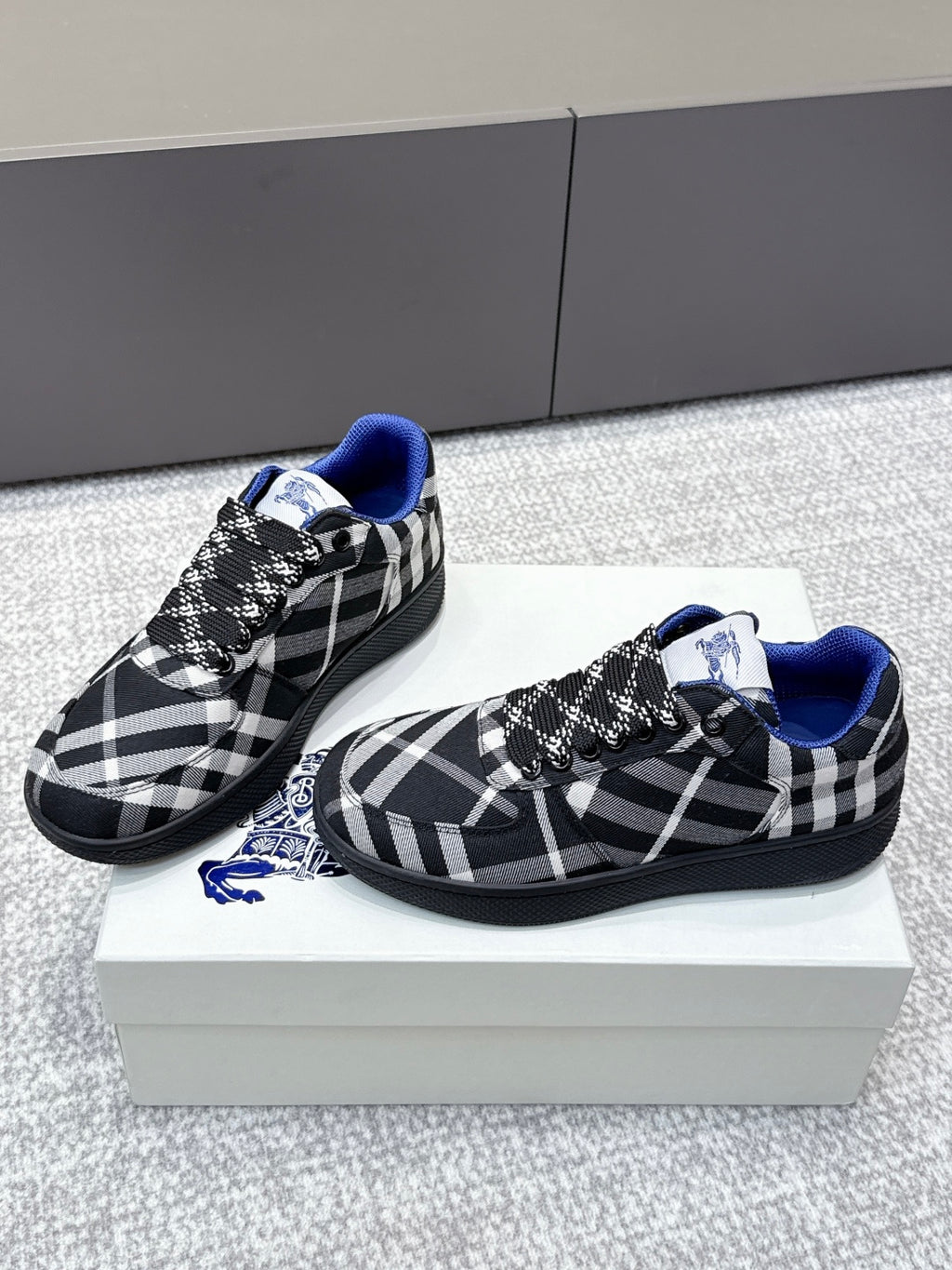 Pair of check-pattern sneakers with blue trim and black lace-up detail