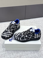 Pair of check-pattern sneakers with blue trim and black lace-up detail