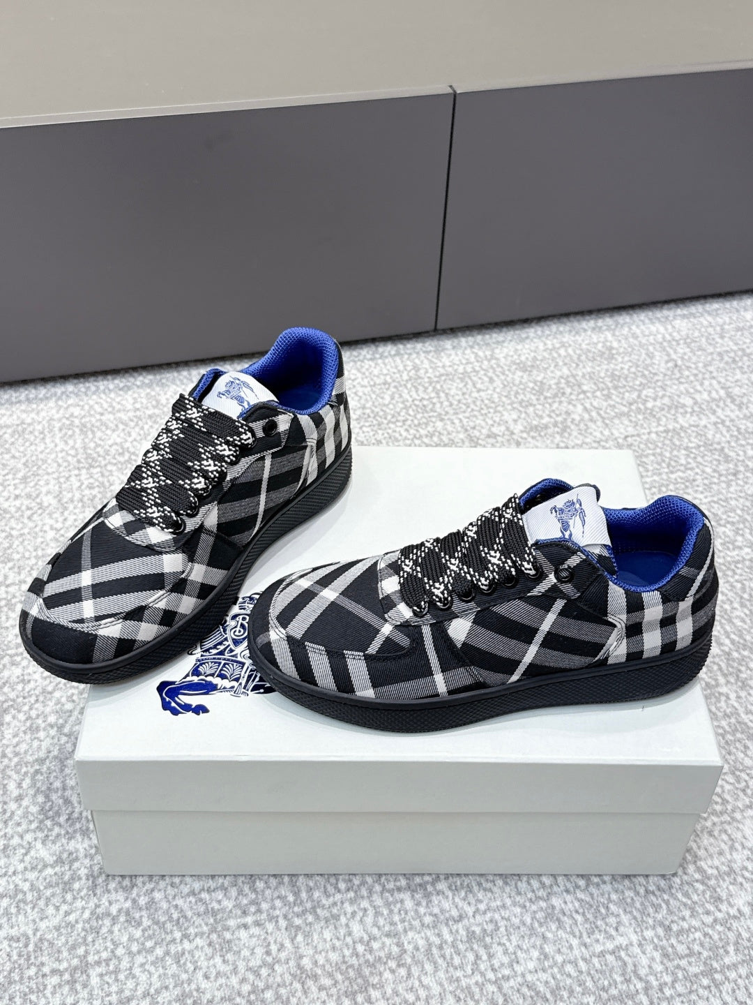Pair of check-pattern sneakers with blue trim and black lace-up detail