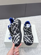 Front view check-pattern sneakers with blue lining and black lace-up upper