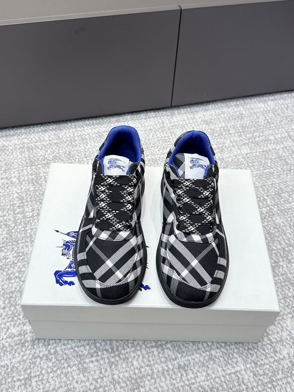 Check-pattern sneakers with blue lining, black laces, and textured rubber sole