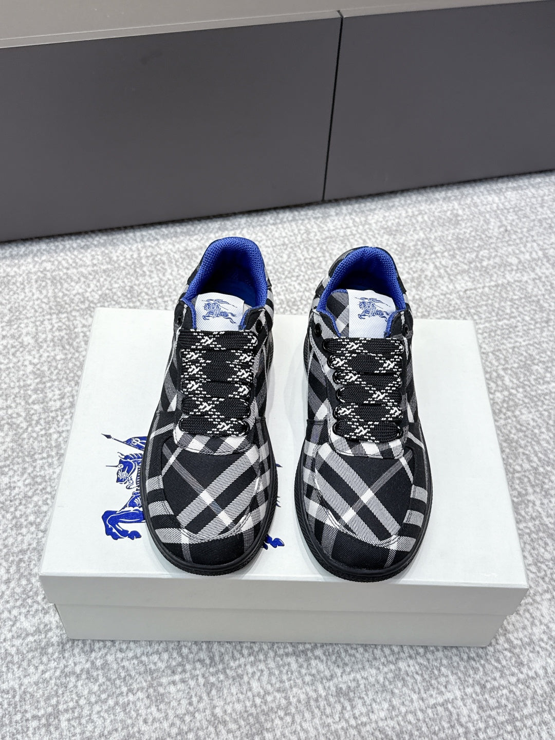 Check-pattern sneakers with blue lining, black laces, and textured rubber sole