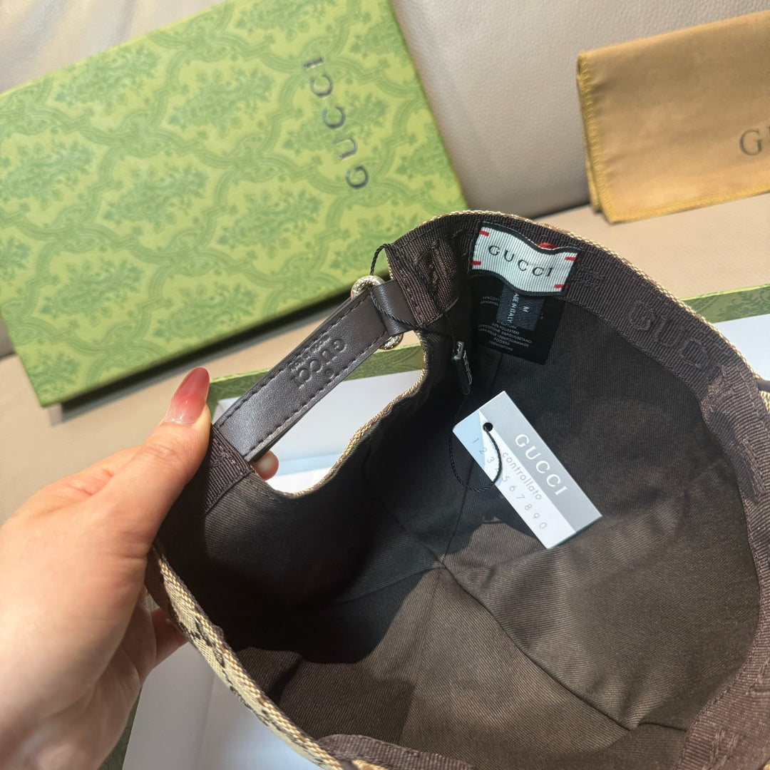 Black GG baseball cap interior with adjustable strap and size tag on brim.
