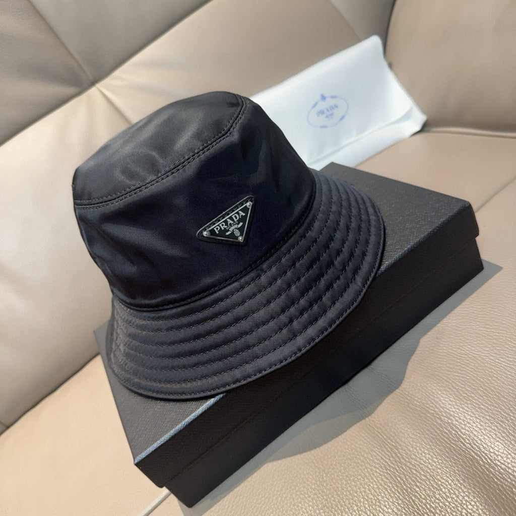 Prada black quilted bucket hat with leather trim and logo plaque