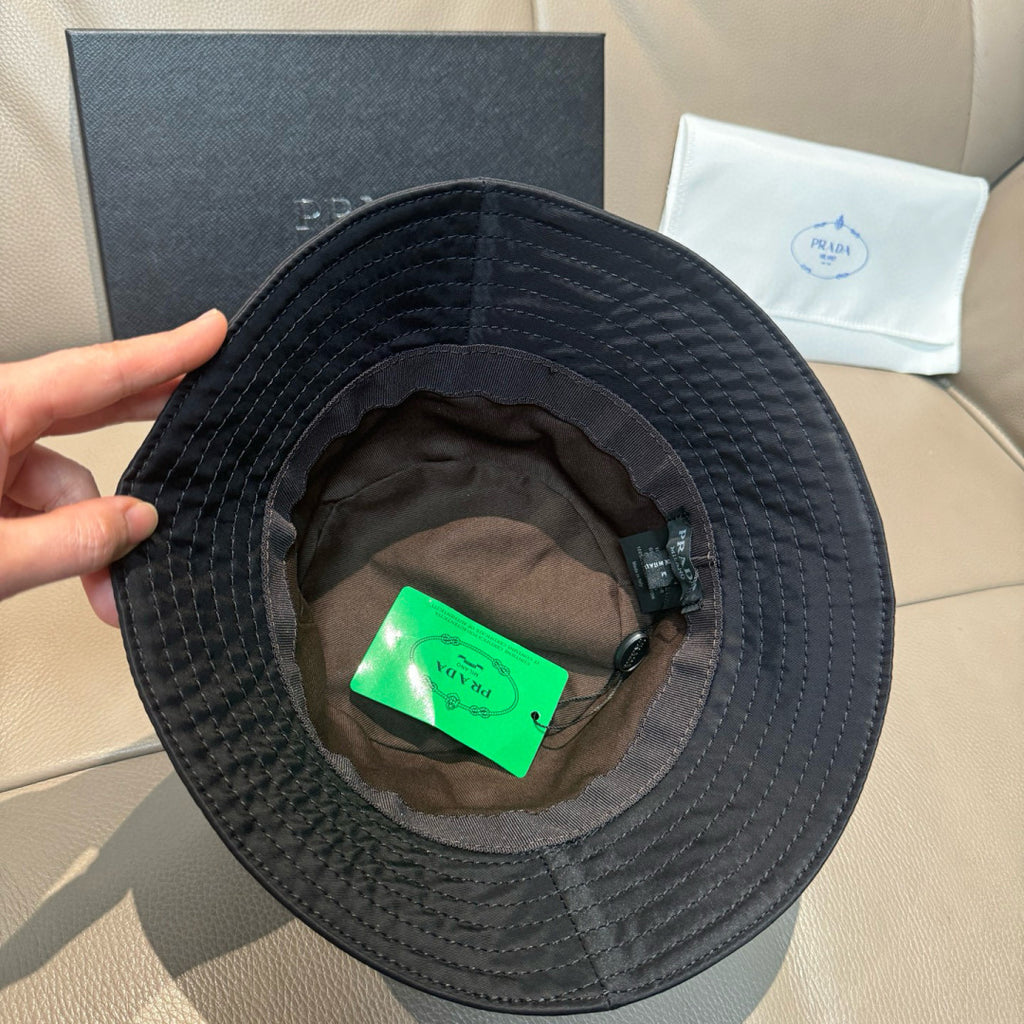 Prada black bucket hat interior with green tag and adjustable strap