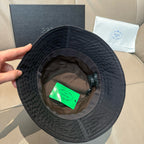 Prada black bucket hat interior with green tag and adjustable strap