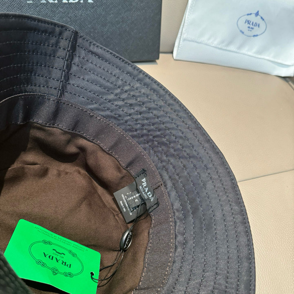 Prada bucket hat interior lining with green tag and stitched brim