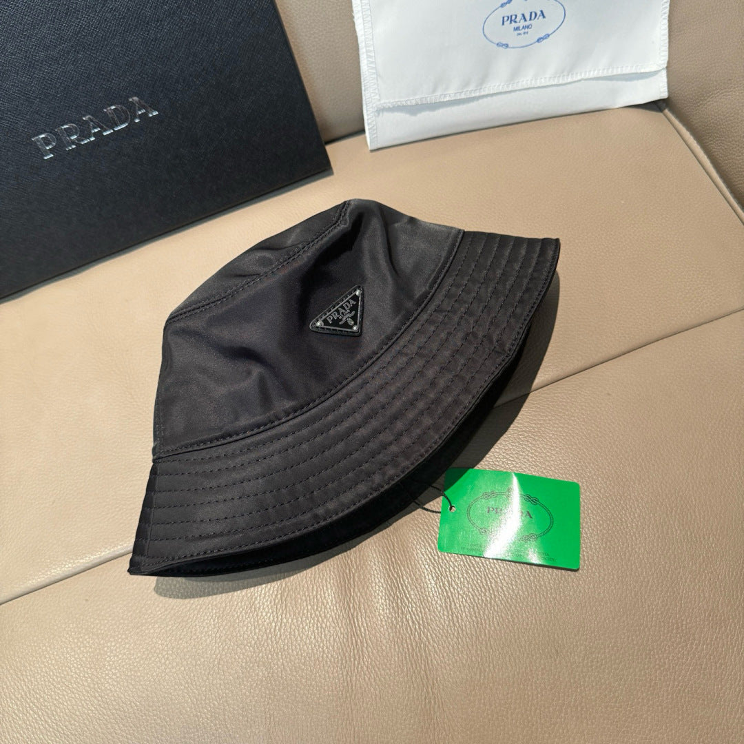 Prada black bucket hat with interior tag and triangular logo badge