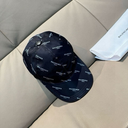 Balenciaga cap in dark navy with repeating BALENCIAGA logo text all over.